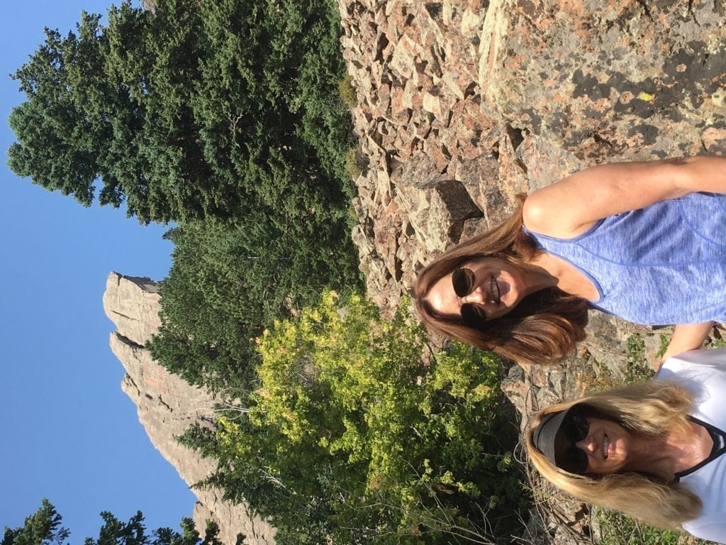 People hiking Flat Irons behind Boulder