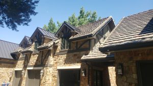 New roof installation by New Roof Plus. Stone-coated steel, metal and tile were blended to make this new Denver area roof look incredible.